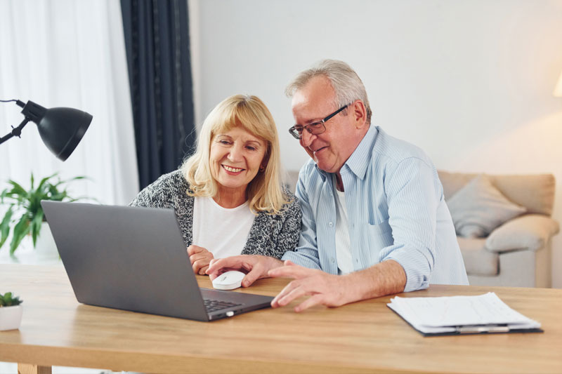 Older couple receiving good news from tax attorney