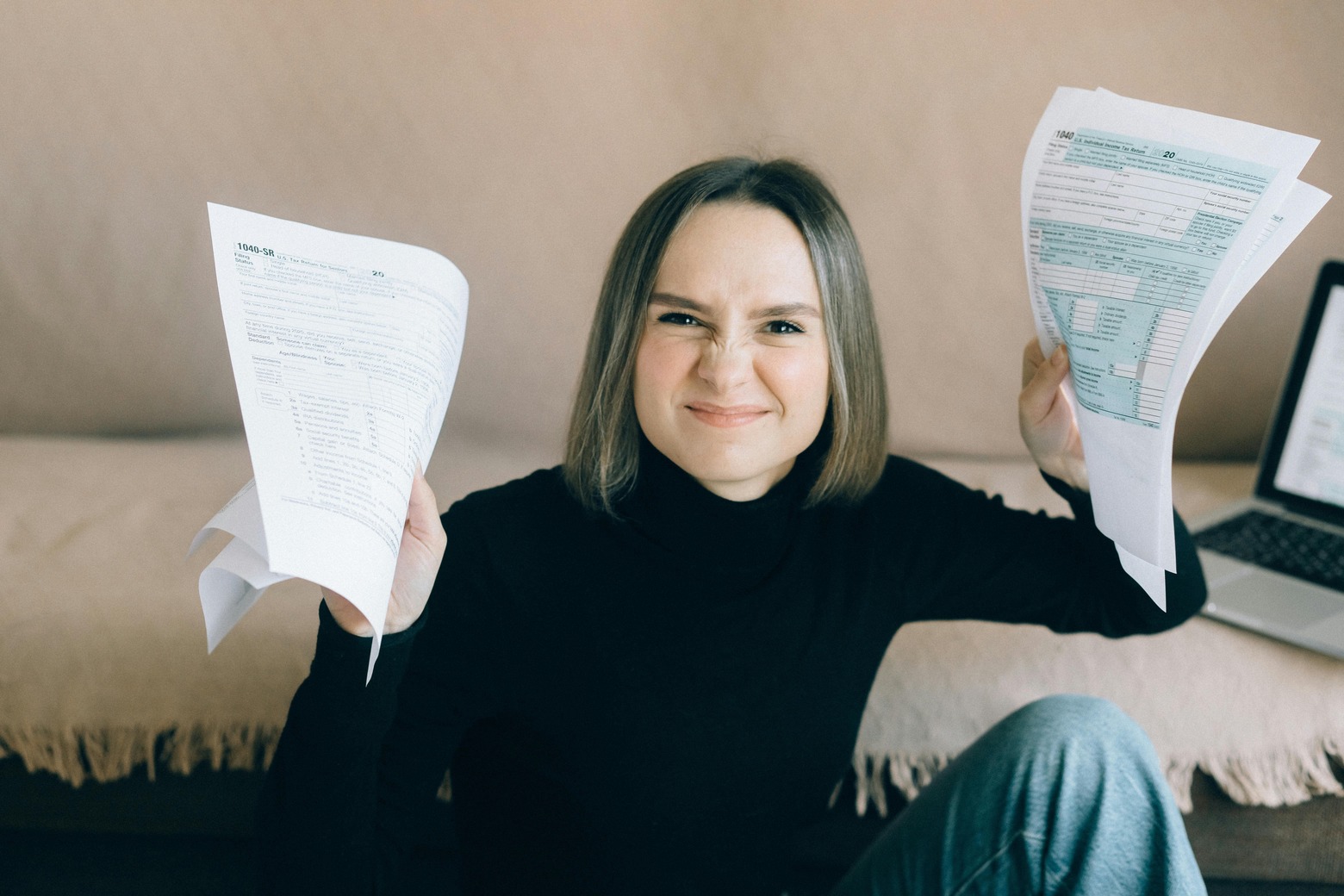 A woman holding documents for tax preparation