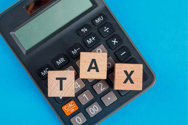 tax audit with wooden cubes on calculator