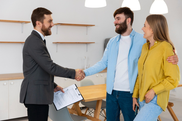 Couple shaking hands with advisor about Offer in Compromise