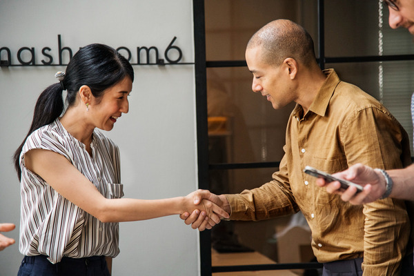 Man and woman shaking hands in professional business setting
