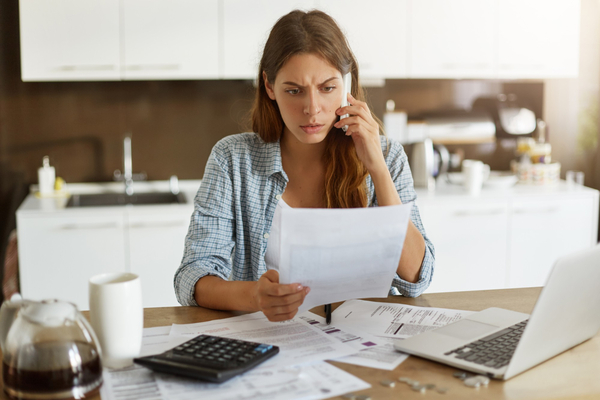 Woman reviewing tax documents discovering red flags that trigger an IRS audit