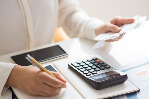 Female doing monthly expense calculation