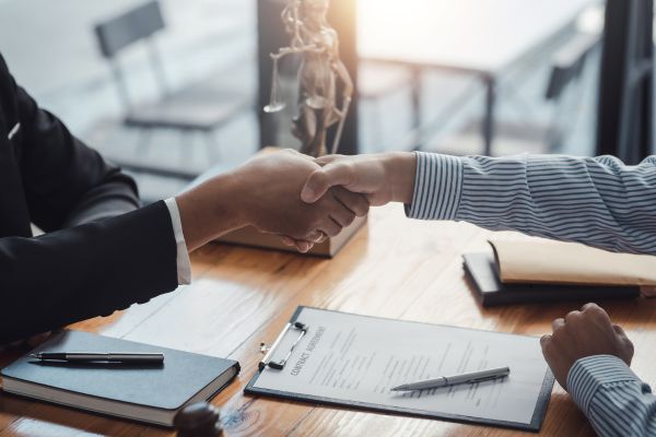 Tax agency lawyer and client reaching an agreement.