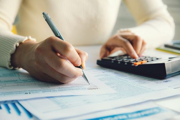 Woman reviewing financial documents for tax compliance