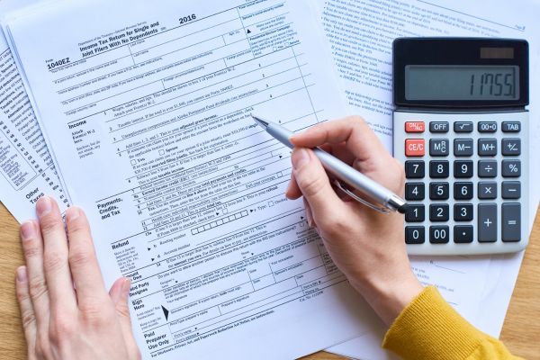 A person filling out tax forms.