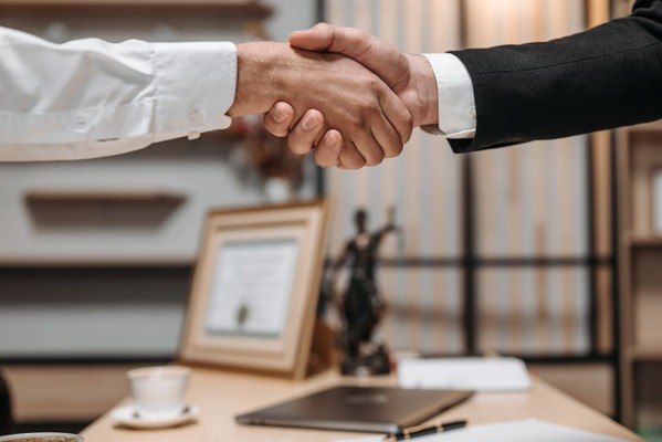 A handshake between a client and a tax professional