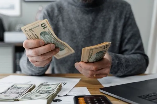 Man budgeting personal finances affected by wage garnishment.
