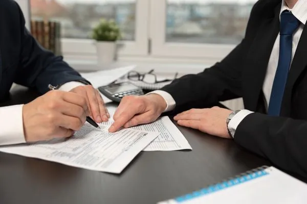 A man consulting with a tax lawyer about a tax levy.