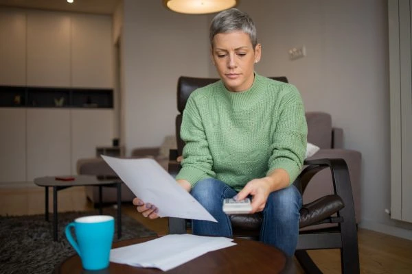 Woman reviewing overpaid wage garnishment paperwork