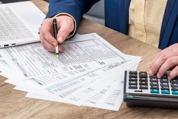 Man preparing and filing tax documents